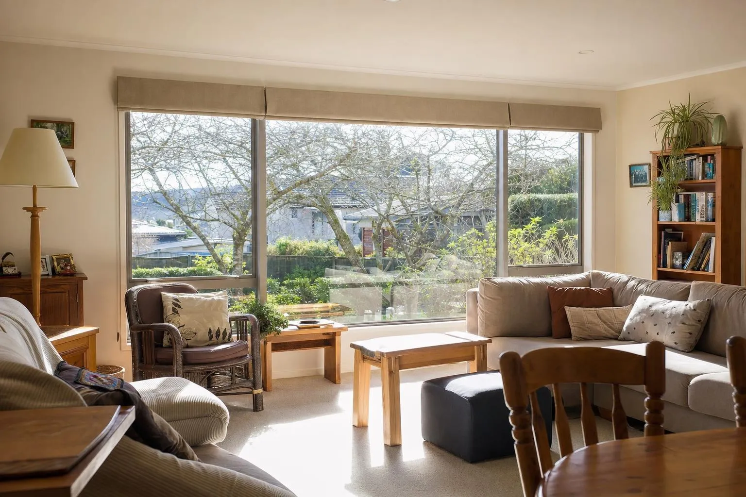 Illustrative: a family lounge with a wide aluminium double glazed window and winter sun