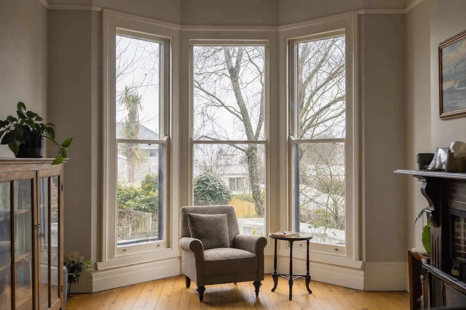Illustrative: a villa bay of tall painted timber sash windows with slim double glazing and native timber floorboards